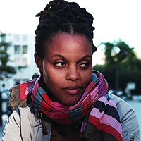 A headshot of a college professor wearing a colorful scarf